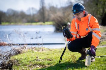 THAMES WATER engineer taking water samples from river